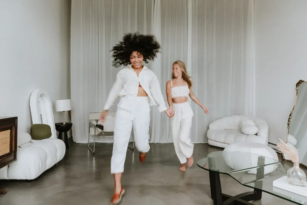 Women playfully dancing to regulate their nervous systems.