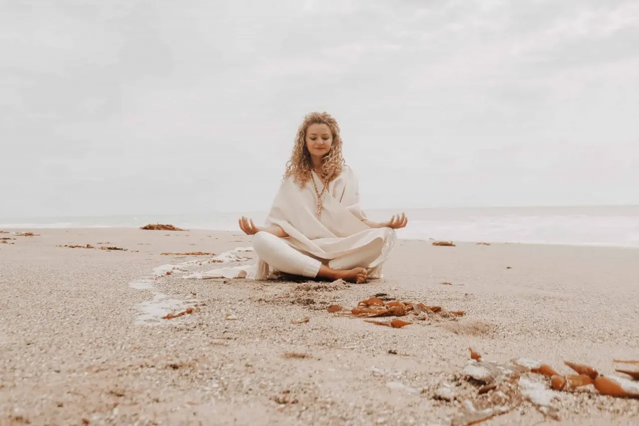 woman meditating for inner peace on the beach